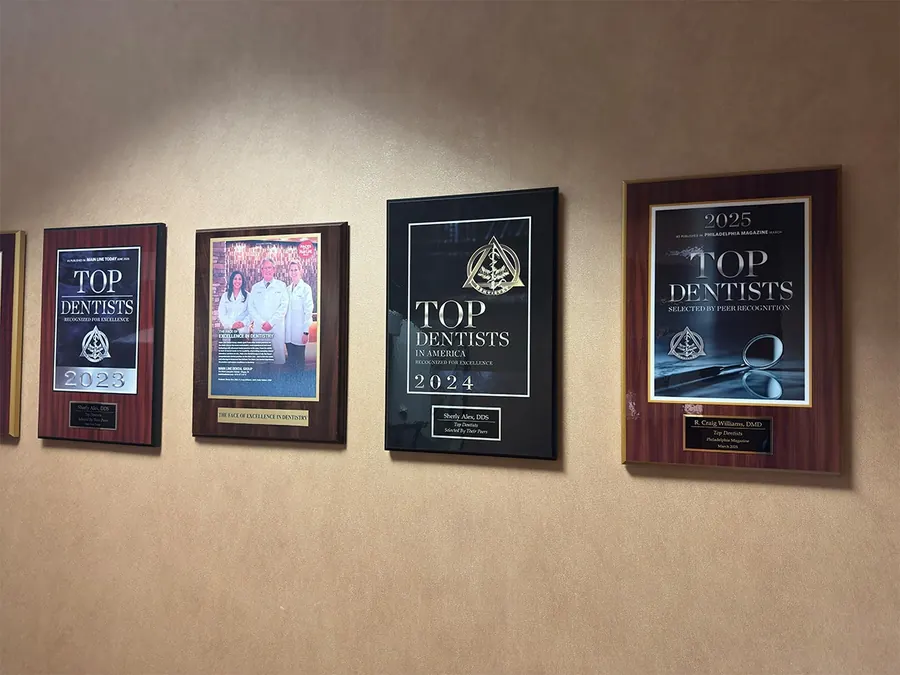 Framed Top Dentists awards on the wall at Main Line Dental Group.