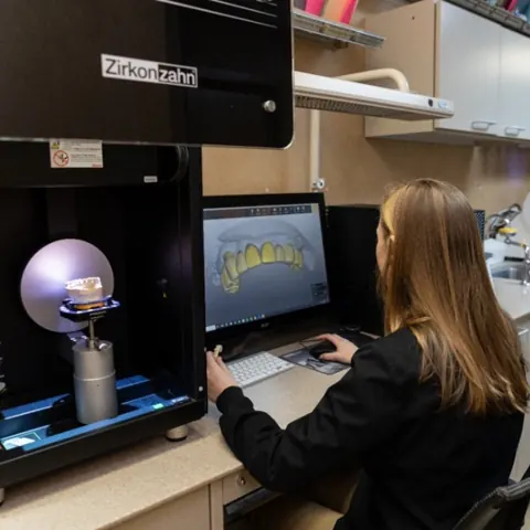 A team member scanning a model on the Zirkonzahn system in our lab.
