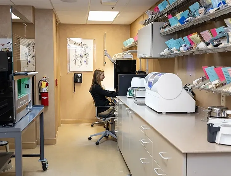 A team member at work in the in-house dental lab.