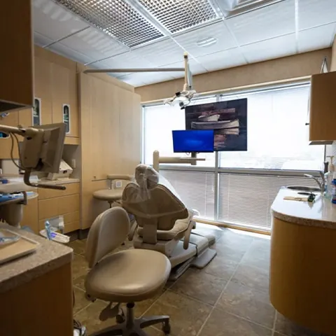 A treatment room with a ceiling-mounted screen.