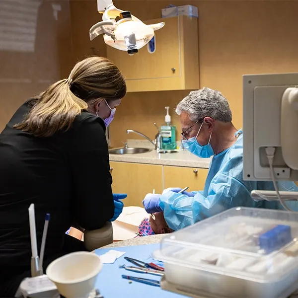 A dentist and an assistant during a procedure.