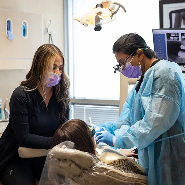 Two of our dentists treating a patient.